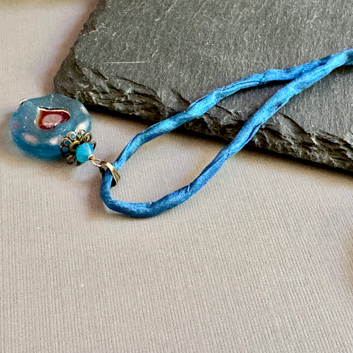 Royal Blue Czech Glass Heart Pendant Necklace on Silk Cord in Antique Brass