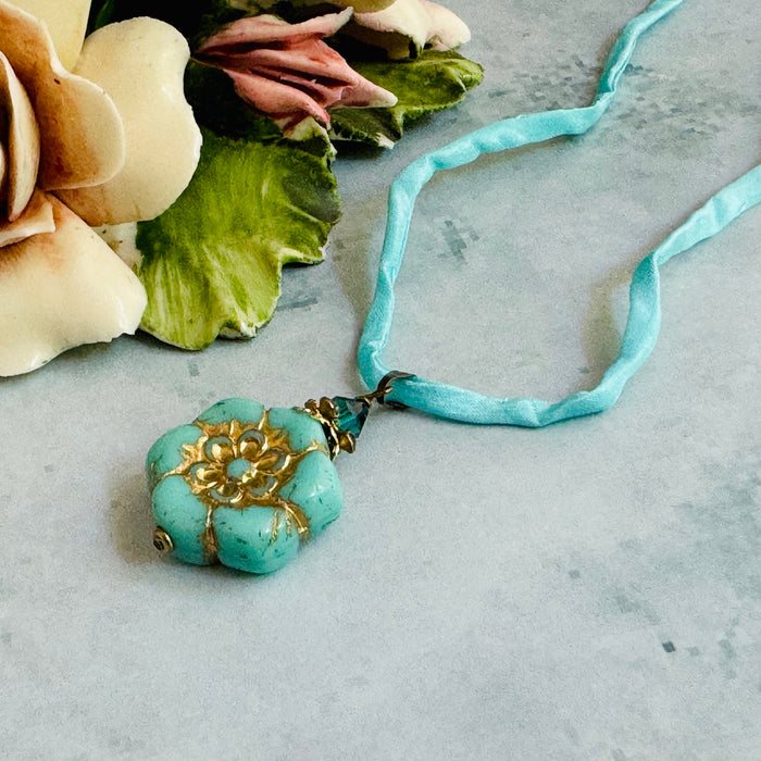 Light Teal Czech Glass Flower Pendant Necklace on Silk Cord in Antique Brass