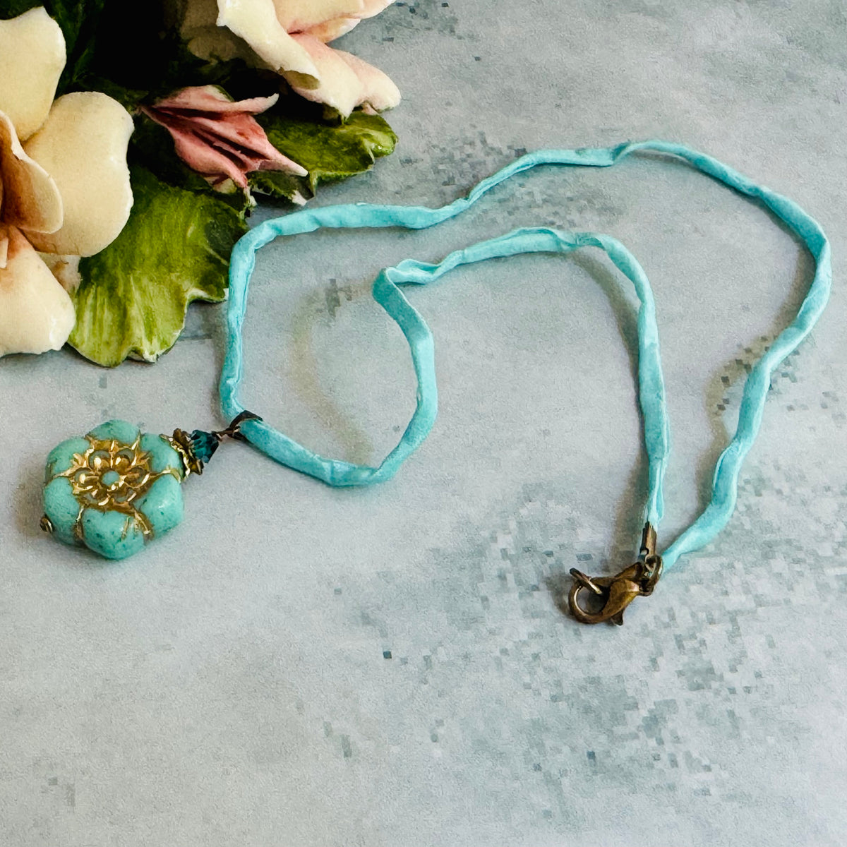 Light Teal Czech Glass Flower Pendant Necklace on Silk Cord in Antique Brass