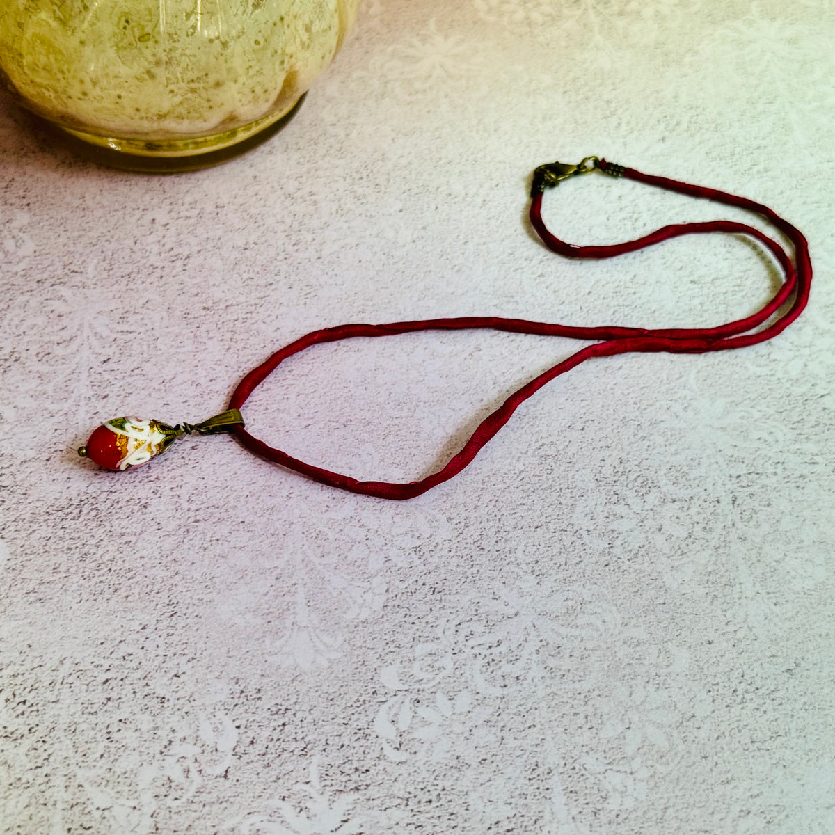 Red Oval Wedding Cake Necklace on Red Silk Cord