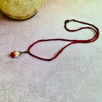 Red Oval Wedding Cake Necklace on Red Silk Cord