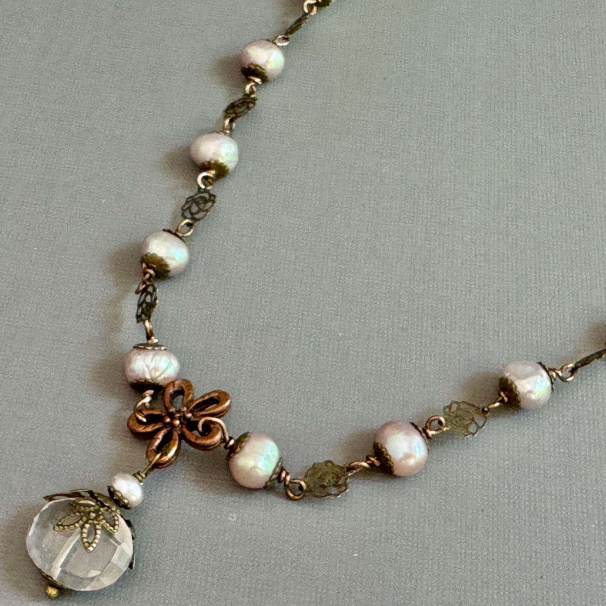 Necklace with pearls and decorative elements on a gray background