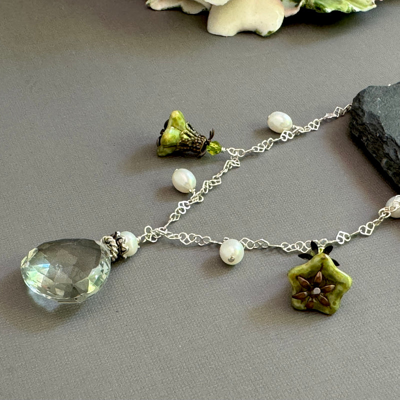 Necklace with green amethyst pendant and Czech glass on a gray surface