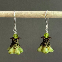 Pair of green flower-shaped earrings with antique brass components. 