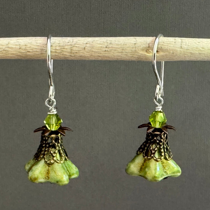 Pair of green flower-shaped earrings with antique brass components. 