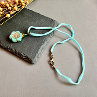 Light Teal Czech Glass Flower Pendant Necklace on Silk Cord in Antique Brass