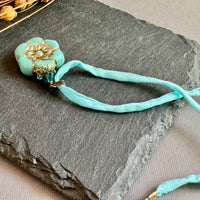 Light Teal Czech Glass Flower Pendant Necklace on Silk Cord in Antique Brass