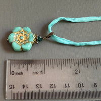 Light Teal Czech Glass Flower Pendant Necklace on Silk Cord in Antique Brass