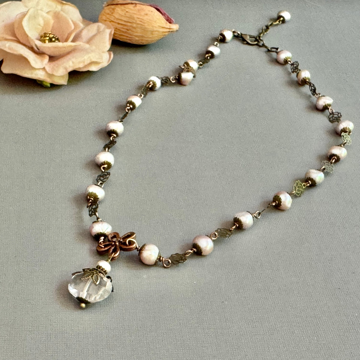 Necklace with pink pearls and a antique brass components.