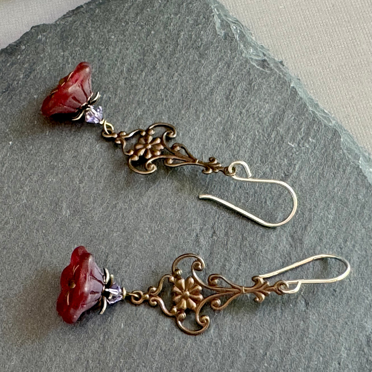 Red Czech bell flower earrings in antique brass and sterling silver.