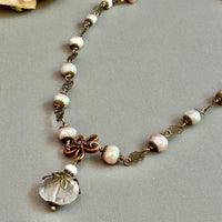 Necklace with pink pearls and pink rose quartz pendant.