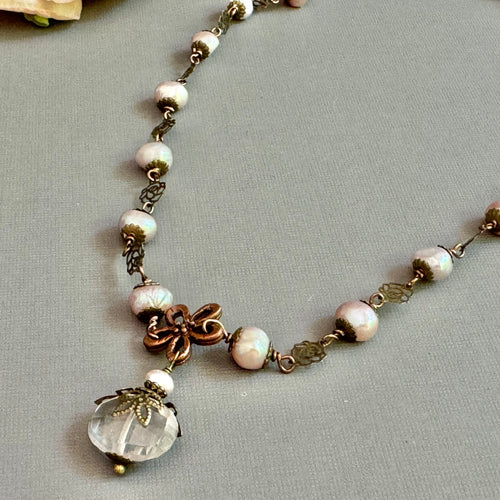 Necklace with pink pearls and pink rose quartz pendant.